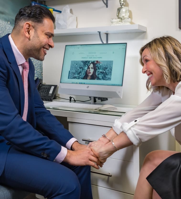 Dr Dev Patel shaking hands with smiling patient